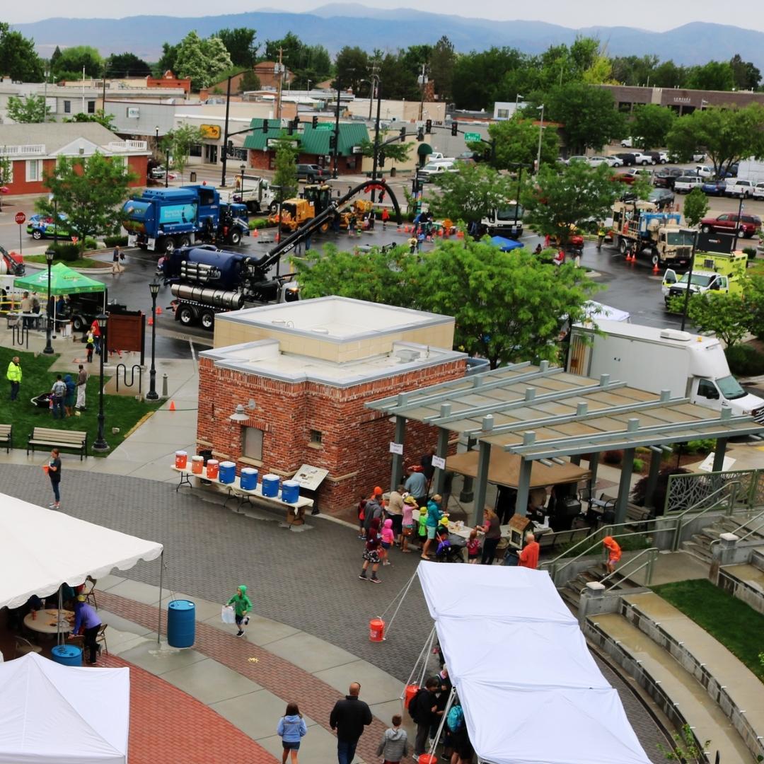 Aerial view of Expo showing tents, large trucks in the parking lot, and people meandering at the event